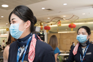 Crew members from the China Eastern flight  from Wuhan, China after landing in Sydney.