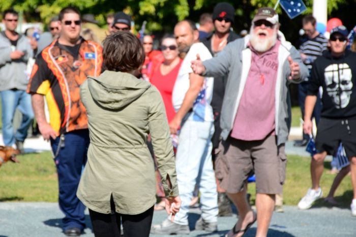 Anti-racism protester approaches and argues with Reclaim Australia demonstrators in Mackay.