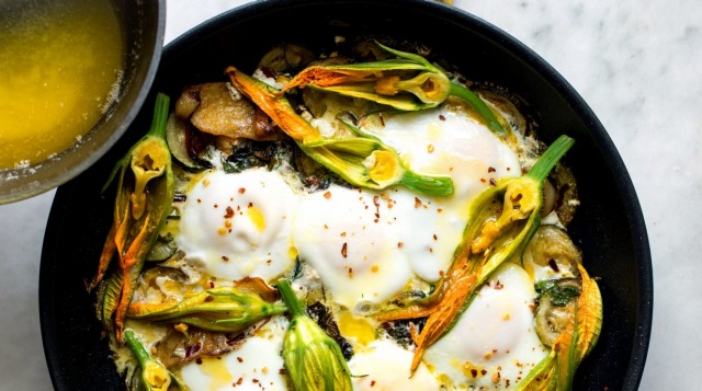 Melted butter adds the finishing touch to the braised egg dish, which features zucchini flowers.