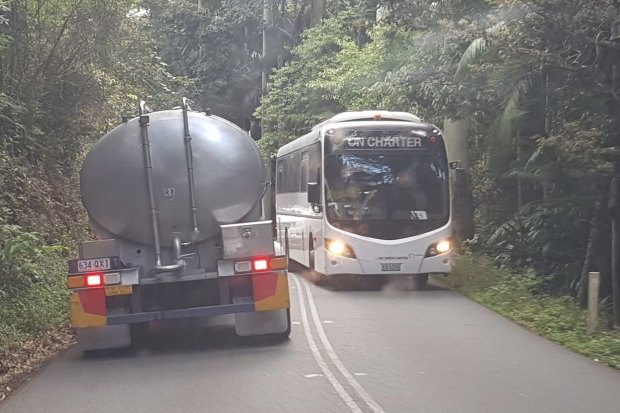 A water carrier passes a tourist bus on Tamborine Mountain. No new underground water bores are allowed for twelve months while detailed studies are completed.