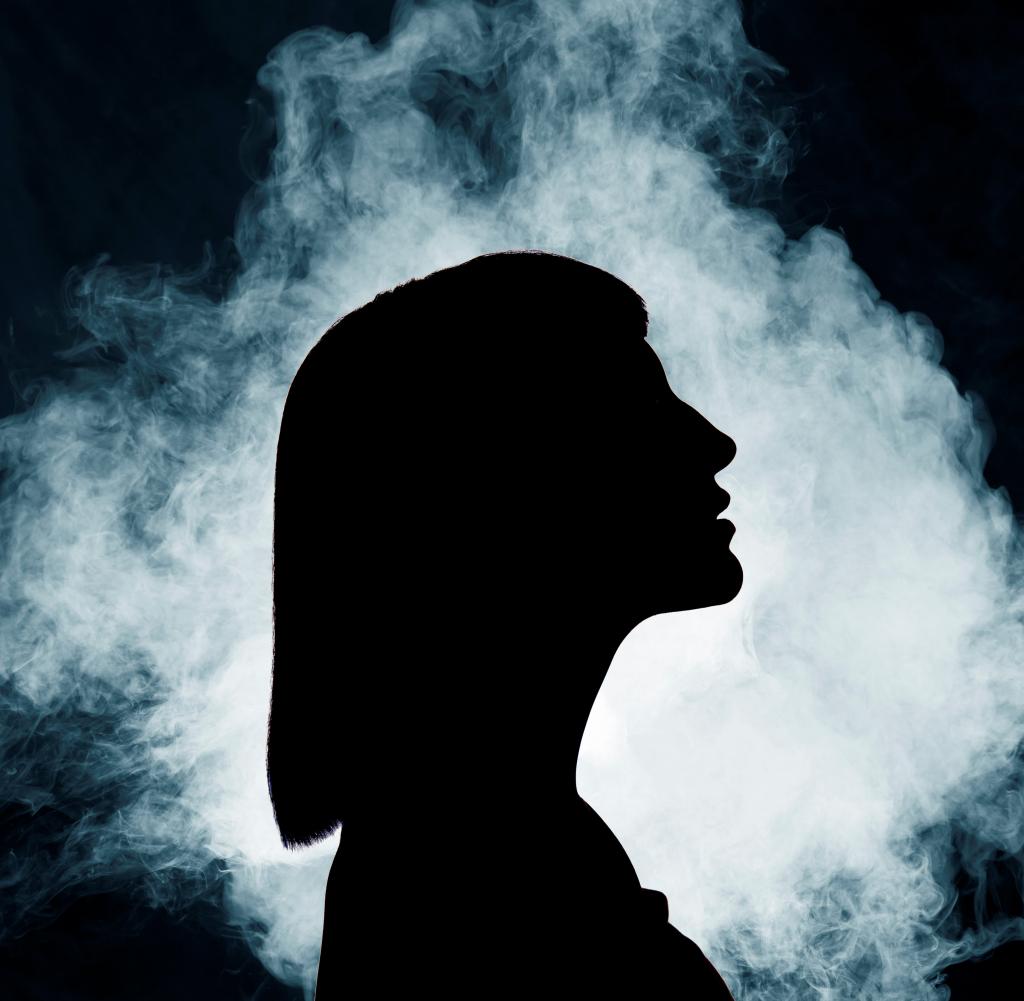 silhouette of woman with smoke