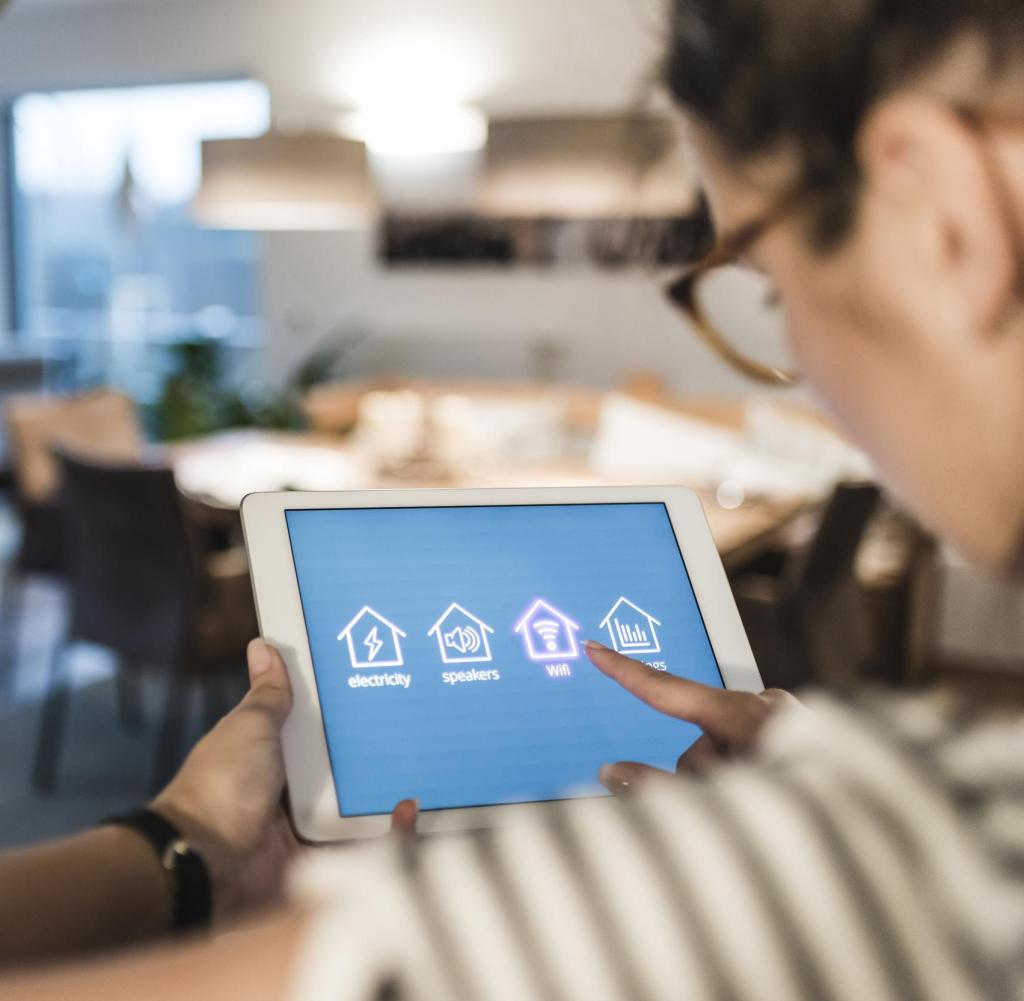 Woman using tablet with smart home control functions at home