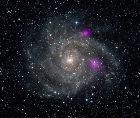 File - This new view of spiral galaxy IC 342, also known as Caldwell 5, includes data from NASA's Nuclear Spectroscopic Telescope Array, or NuSTAR. High-energy X-ray data from NuSTAR have been translated to the color magenta, and superimposed on a visible-light view highlighting the galaxy and its star-studded arms.