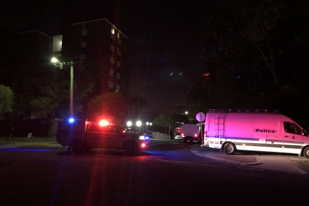 Forensics and an ambulance at the crime scene. 