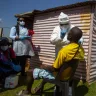 Health workers collects samples for coronavirus testing outside a shack to combat the spread of COVID-19 at Lenasia South, South Johannesburg, South Africa, 