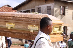 Dancing Pallbearers as they perform the role of carrying the coffin for funerals in Igarra, Nigeria