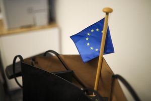 An EU flag rests inside a handbag at the office of British European Parliament member Judith Kirton-Darling as she packs some of her belongings at the European Parliament in Brussels, Monday, Jan. 27, 2020.