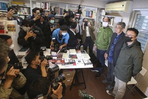 Lam Wing-kee, second from right, one of five shareholders and staff at the Causeway Bay Book shop in Hong Kong, is stands with Taiwan's Legislative Yuan Speaker Yu Shyi-kun, third from right, on the opening day of his new book shop in Taipei, Taiwan, Saturday, April 25, 2020.