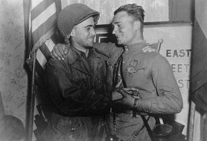 File - In an arranged photo commemorating the meeting of the Soviet and American armies, 2nd Lt. William Robertson (U.S. Army) and Lt. Alexander Silvashko (Red Army) stand facing one another with hands clasped and arms around each other's shoulders. Elbe Day, April 25, 1945, is the day Soviet and American troops met at the Elbe River, near Torgau in Germany, marking an important step toward the end of World War II in Europe.