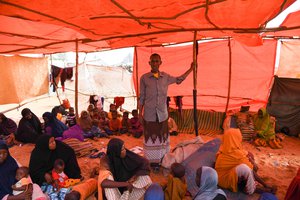 File - Internally displaced persons (IDPs) fleeing drought seek assistance at Al Adala temporary camp, Mogadishu, Somalia,26 March 2017. Hassan Buule Aden (centre) explained: “Our livestock died and crops dried up. We fled from hunger and thirst.”