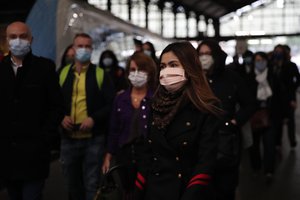 Commuters wearing the compulsory face mask in public transports exit a train at the Saint Lazare train station, in Paris, France