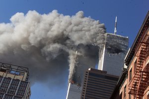 File - In this Sept. 11, 2001 file photo smoke rises from the burning twin towers of the World Trade Center after hijacked planes crashed into the towers, in New York City.