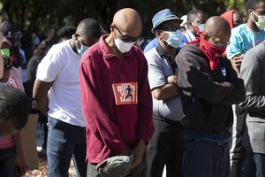 People pray during a rally to protest the shooting of Ahmaud Arbery, an unarmed black man Friday, May 8, 2020, in Brunswick, Georgia.