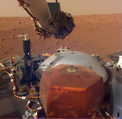 This image from InSight's robotic-arm mounted Instrument Deployment Camera on Mars shows the instruments on the spacecraft's deck, with the Martian surface of Elysium Planitia in the background.