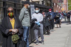 Harlem resident Eleanor Kennedy, left, waits in line during a COVID-19 antibody test drive at the Abyssinian Baptist Church, Thursday, May 14, 2020, in the Harlem neighborhood of the Manhattan.