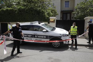 Police officers stand outside the house of the Chinese ambassador In the central Israeli city of Herzliya, Sunday, May 17,2020. The Chinese ambassador to Israel was found dead in his home north of Tel Aviv on Sunday, Israel's Foreign Ministry said.