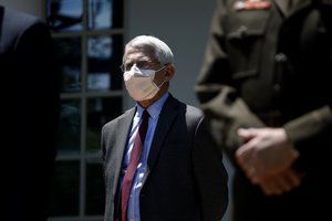 Director of the National Institute of Allergy and Infectious Diseases Dr. Anthony Fauci listens as President Donald Trump speaks about the coronavirus in the Rose Garden of the White House, Friday, May 15, 2020, in Washington.