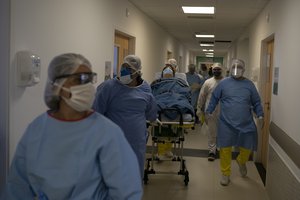 Medical workers move new coronavirus patient Rosane Pacheco to be treated at the Dr. Ernesto Che Guevara hospital in Marica, Brazil, Thursday, May 21, 2020.