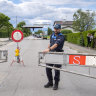 Border guards opens the border crossing in Thonex, near Geneva in Switzerland, on Sunday.