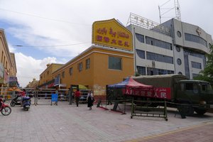 File - Armed police and a metal detector at the Kargilik bazaar in Xinjiang, China.