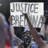 A protester holds a sign during a march over the deaths of George Floyd and Breonna Taylor this month.