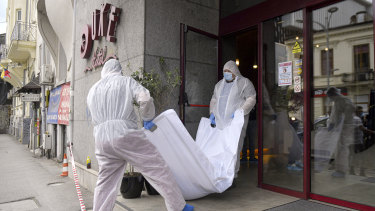 Forensic workers carry the body of Gholamreza Mansouri from a hotel in  Bucharest, Romania