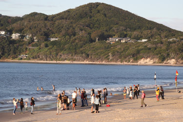 Beachgoers are seen on the sand at Byron Bay, NSW, Saturday, June 6, 2020. Coronavirus restrictions are slowly being eased across Australia with states and territories at different stages on the roadmap to reopen the nation. (AAP Image/Jason O'Brien) NO ARCHIVING