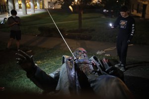 People film the only statue of a Confederate general, Albert Pike, in the nation's capital after it was toppled by protesters and set on fire in Washington early Saturday, June 20, 2020