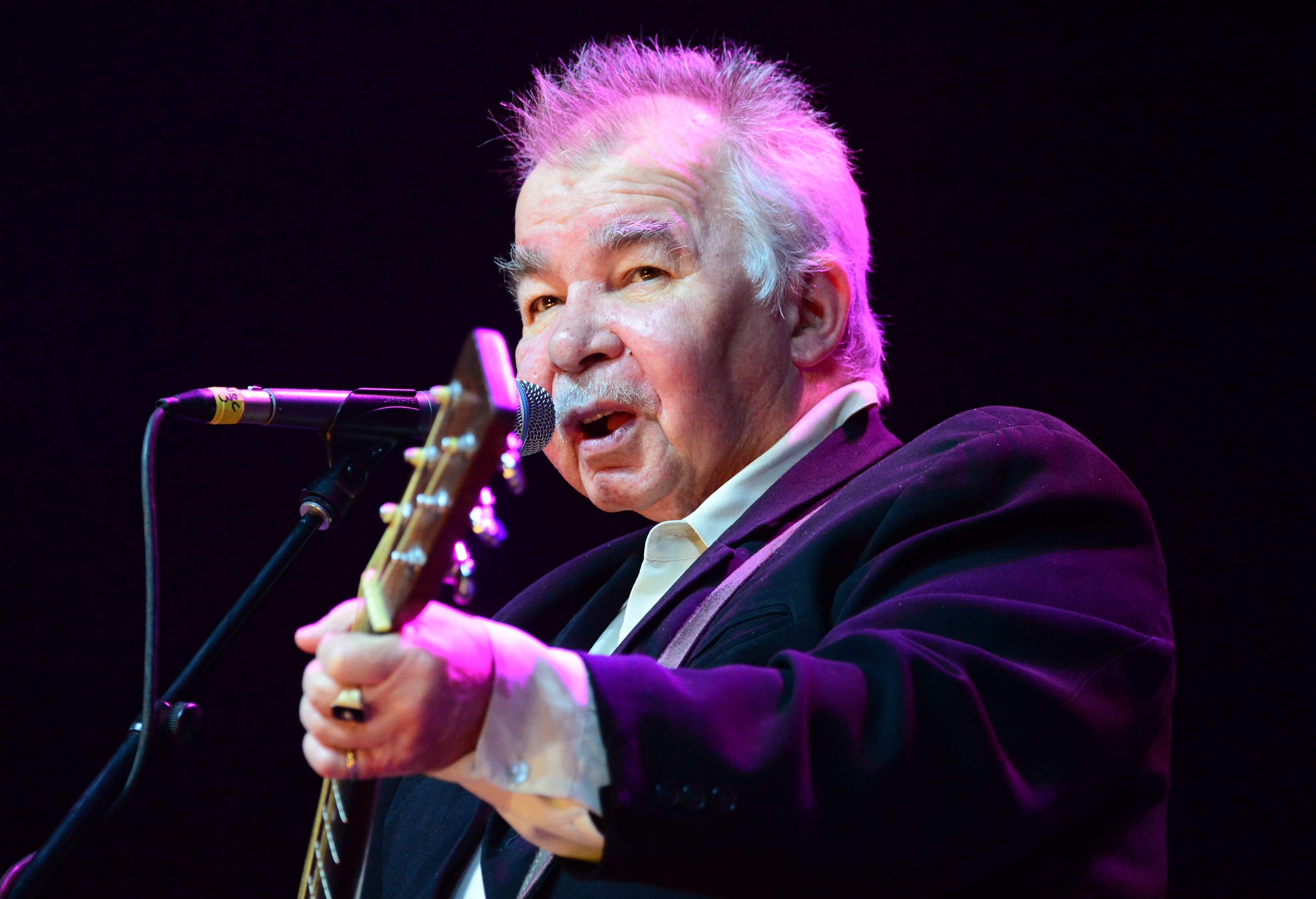 FILE: Singer-songwriter John Prine is in critical condition after being hospitalized for sudden COVID-19 symptoms on March 26. The Prine family shared the news on March 29 via Twitter. INDIO, CA - APRIL 27: Musician John Prine performs onstage during day 3 of 2014 Stagecoach: California’s Country Music Festival at the Empire Polo Club on April 27, 2014 in Indio, California. (Photo by Frazer Harrison/Getty Images for Stagecoach) ORG XMIT: 775455142