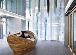 The Waterveil glass panels next to the concierge desk, lit from behind by sunlight.