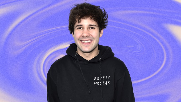 A photo of David Dobrik on a blue swirled backgorund