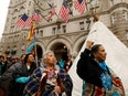 Indigenous leaders protest outside of a Trump building.