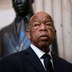 Rep. John Lewis standing in front of a bust of Rev. Martin Luther King Jr.