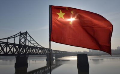 The Chinese flag flies on the Yalu River Broken Bridge.