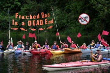 Kayactivists take part in a rally at Camp Kalama in Kalama, Wash., on May 18, 2019, calling for the Washington Department of Ecology to deny permits for Northwest Innovation Works (NWI) proposed methanol refinery. Governor Inslee recently reversed his stance on the $2 billion dollar facility which would convert natural gas into methane for export via ship to China where it will be used in the production of plastics. (Photo by: Alex Milan Tracy)