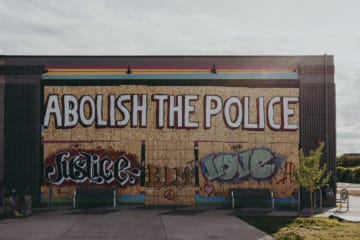 "Abolish the police" graffitied on boards outside Moon Palace Books at 3032 Minnehaha Avenue in Minneapolis, Minnesota. (Photo: Tony Webster on Flickr).