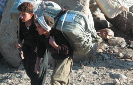 Smuggling is necessary but dangerous work for these Kurdish boys. Many are killed every year by Iranian border patrols. Rahman Hassani/Alamy