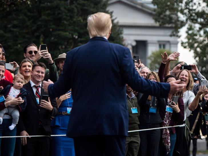 Donald J. Trump stands in front of White House visitors.