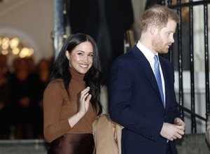 Britain's Prince Harry and Meghan, Duchess of Sussex smile as they leave Canada House, in London