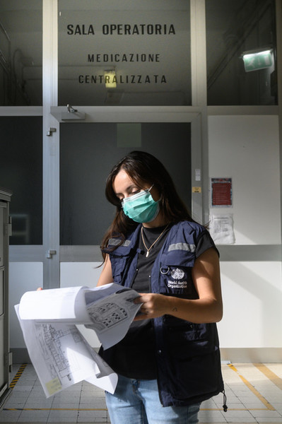 A hospital readiness consultant studying the floor plan of a hospital in Bologna, Italy