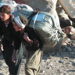 Smuggling is necessary but dangerous work for these Kurdish boys. Many are killed every year by Iranian border patrols. Rahman Hassani/Alamy