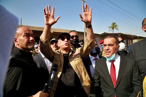 Iraqi Prime Minister Mustafa al-Kadhimi waves to residents of Tarmiyah, where a commander of an Iraqi army brigade was killed last week in an attack blamed on the Islamic State group, in Tarmiyah, 35 kilometers (20 miles) north of Baghdad, Iraq, Monday, July 20, 2020.