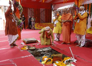 Indian Prime Minister Narendra Modi, center, performs the groundbreaking ceremony of a temple dedicated to the Hindu god Ram, watched by Rashtriya Swayamsevak Sangh (RSS) chief Mohan Bhagwat, right, and others in Ayodhya, India, Wednesday, Aug. 5, 2020.