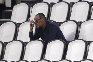 Juventus' head coach Maurizio Sarri smokes during a Serie A soccer match between Juventus and Roma, at the Allianz stadium in Turin, Italy, Saturday, Aug.1, 2020.