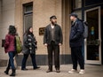 An older and younger man stand on a New York street.