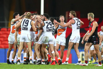 Callan Ward of the Giants is congratulated by team mates after kicking the goal that sealed the match. 