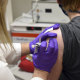 the first patient enrolled in Pfizer's COVID-19 coronavirus vaccine clinical trial at the University of Maryland School of Medicine in Baltimore, receives an injection.