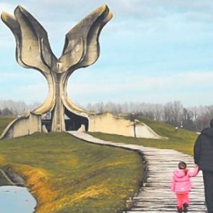 A father and his young daughter visit the Stone Flower monument at Jasenovac. Designed by the famous Serb architect Bogdan Bogdanović, it is a memorial to the victims of Ustasha atrocities during the Second World War. FERDINANDO PIEZZI/ALAMY