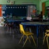 Tables and chairs set up in an empty classroom