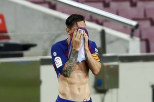 Barcelona's Lionel Messi reacts during a Spanish La Liga soccer match between Barcelona and Osasuna at the Camp Nou stadium in Barcelona, Spain, Thursday, July 16, 2020